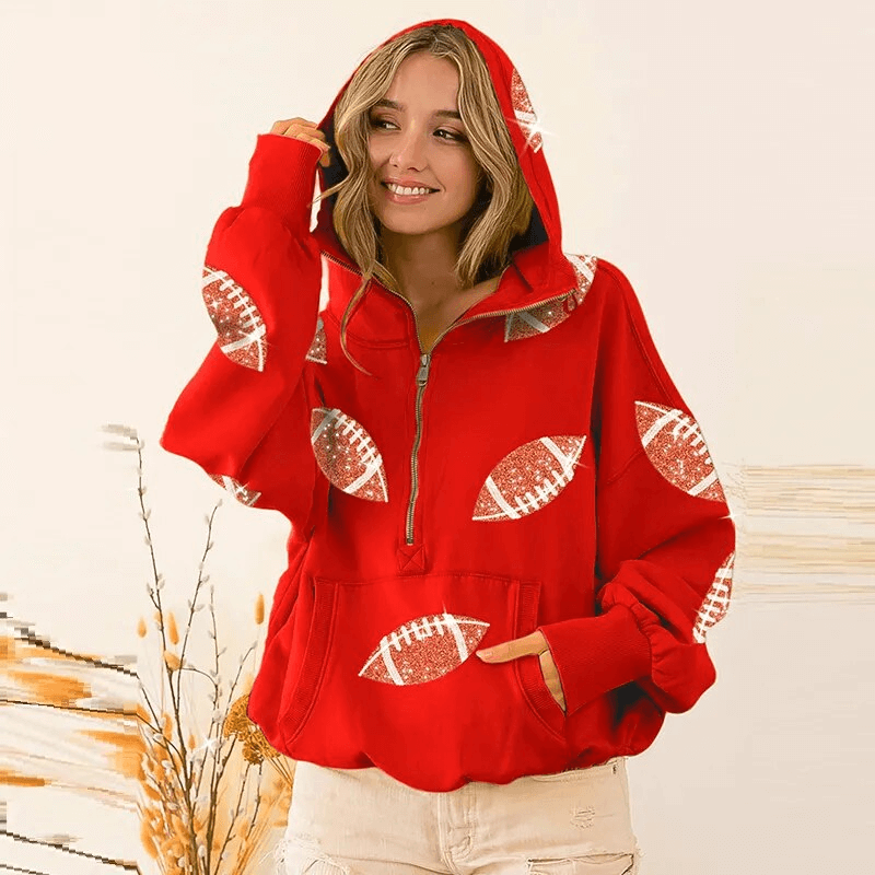 Woman wearing a red sporty casual women's hoodie with front pockets and hood, adorned with football-shaped sequins. Perfect for activities.